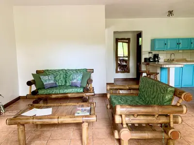 a living room with a couch and a table at EcoCondo 5 in Secured Community Paradise w pool in Quepos