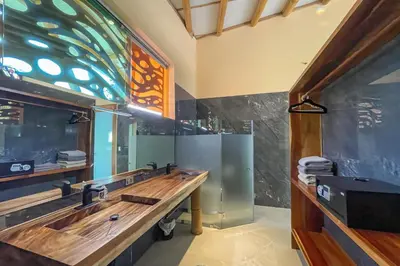 a bathroom with two sinks and a mirror at Brand New Villa Bambú with large pool near MA in Quepos