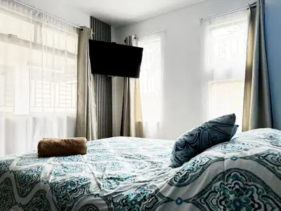 a bedroom with a bed with a stuffed animal on it at Casa Matiza, 7 min SJO airport, free parking, AC in Santiago Este