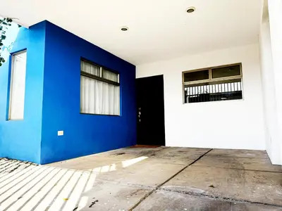 an empty room with a blue wall and windows at Casa Matiza, 7 min SJO airport, free parking, AC in Santiago Este