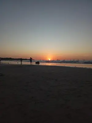 two people standing on the beach at sunset at Casa Mari Black Stallion in Tamarindo