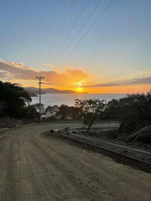 a dirt road with the sunset in the background at Casa Mari Black Stallion in Tamarindo