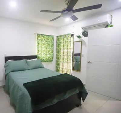 a bedroom with a bed and a ceiling fan at Casa Mari Black Stallion in Tamarindo