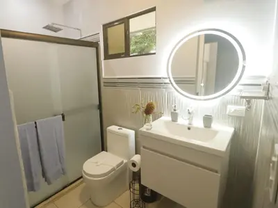 a bathroom with a toilet and a sink and a mirror at Casa Mari Black Stallion in Tamarindo