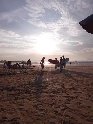 a group of people walking on the beach with surfboards at Casa Mari Black Stallion in Tamarindo