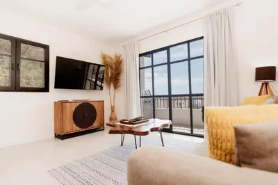 a living room with a couch and a tv at El Prado: New 2br Condo in Las Catalinas in Playa Danta