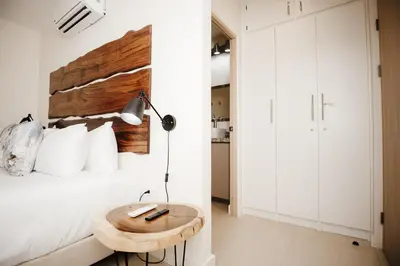 a bedroom with a bed with a wooden headboard at El Prado: New 2br Condo in Las Catalinas in Playa Danta