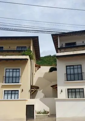 a house with two balconies on the side of it at El Prado: New 2br Condo in Las Catalinas in Playa Danta