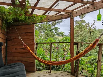 a hammock on the porch of a house at Tipi Bribri in Heredia