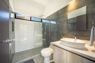 a bathroom with a sink and a toilet and a shower at Casa Encanto Potrero, Flamingo in Liberia