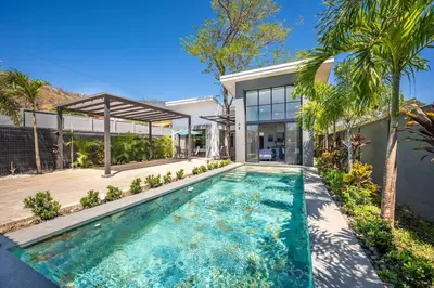 a swimming pool in the backyard of a house at Casa Encanto Potrero, Flamingo in Liberia