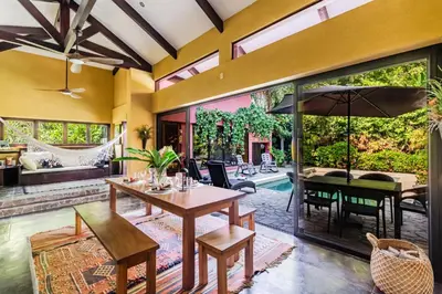 an open living room with a table and chairs at VIP La Lora Beach Villa best family home in Santa Teresa Beach