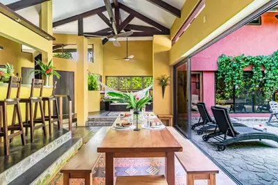 a dining room with a table and chairs at VIP La Lora Beach Villa best family home in Santa Teresa Beach
