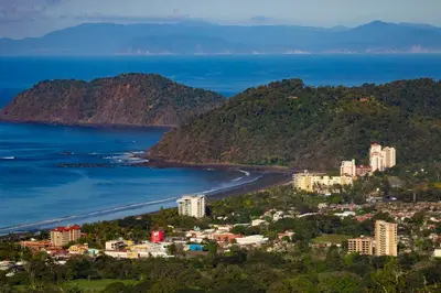 a view of a city and the ocean at Direct Beach & Pool Access l 247 Security in Jacó