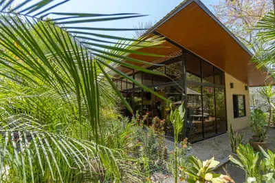 a house with a lot of plants in front of it at Casa Cabo Blanco Mal Pais in Carmen