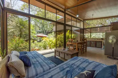 a large bedroom with a bed and a dining room at Casa Cabo Blanco Mal Pais in Carmen