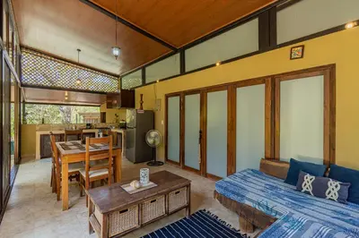 a living room with a bed and a dining room at Casa Cabo Blanco Mal Pais in Carmen