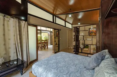 a bedroom with a bed and a dining room at Casa Cabo Blanco Mal Pais in Carmen