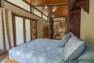a bedroom with a bed with a blue comforter at Casa Cabo Blanco Mal Pais in Carmen