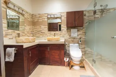 a bathroom with a toilet and a sink and a shower at Ocean and Jungle views! AC, Wi-Fi, kitchen in Manzanillo