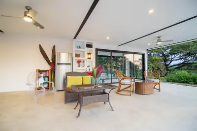 a living room with a couch and a table at Ocean and Jungle views! AC, Wi-Fi, kitchen in Manzanillo