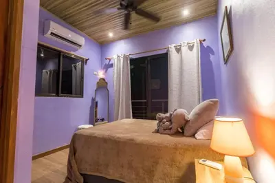 two stuffed animals sitting on a bed in a room at Ocean and Jungle views! AC, Wi-Fi, kitchen in Manzanillo