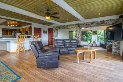 a living room with leather furniture and a table at Ocean and Jungle views! AC, Wi-Fi, kitchen in Manzanillo