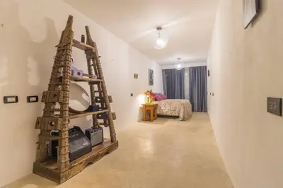 a room with a ladder in the middle of a room at Ocean and Jungle views! AC, Wi-Fi, kitchen in Manzanillo