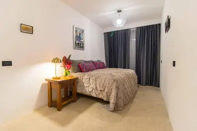 a bedroom with a bed and a table with a lamp at Ocean and Jungle views! AC, Wi-Fi, kitchen in Manzanillo