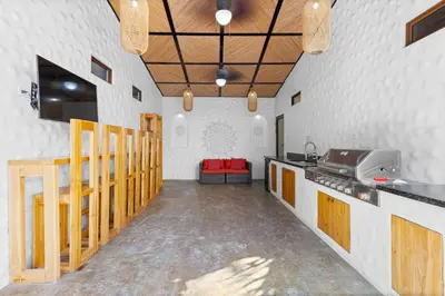 a room with a kitchen with a counter and a table at Modern Home with Chic Bohemian Style and Zen Outdoor Oasis with Swimming Pool and Tiki Style Dining Space in Potrero