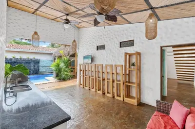 a kitchen and living room with a ceiling fan at Modern Home with Chic Bohemian Style and Zen Outdoor Oasis with Swimming Pool and Tiki Style Dining Space in Potrero
