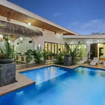 Modern Home with Chic Bohemian Style and Zen Outdoor Oasis with Swimming Pool and Tiki Style Dining Space