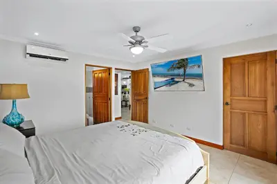 a bedroom with a bed and a ceiling fan at Stylish Flamingo Condo with Ocean Views, Renovated Kitchen & Walkable Beach Access in Playa Flamingo