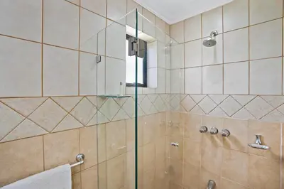a bathroom with a shower with a glass door at Stylish Flamingo Condo with Ocean Views, Renovated Kitchen & Walkable Beach Access in Playa Flamingo