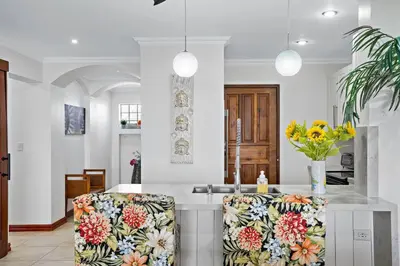 a kitchen with two chairs with flowers on them at Stylish Flamingo Condo with Ocean Views, Renovated Kitchen & Walkable Beach Access in Playa Flamingo