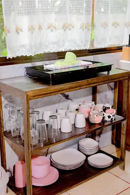 a shelf filled with plates and cups and dishes at Casa Paraíso - La Fortuna in Fortuna