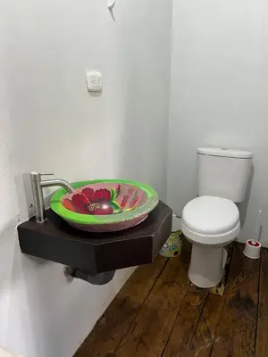 a bathroom with a sink and a toilet at Cabañas MOHE’S Uvita in Uvita