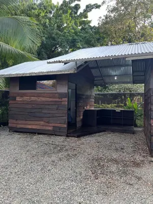 a shed with a metal roof on top of it at Cabañas MOHE’S Uvita in Uvita