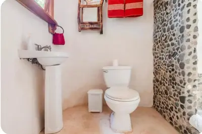 a bathroom with a toilet and a sink at Casa BAMBÚ, enjoy nature in San Juan de Mata
