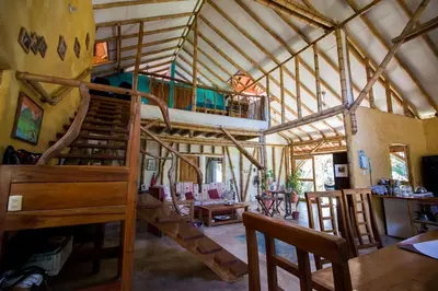 a room with a wooden staircase in a house at Casa BAMBÚ, enjoy nature in San Juan de Mata