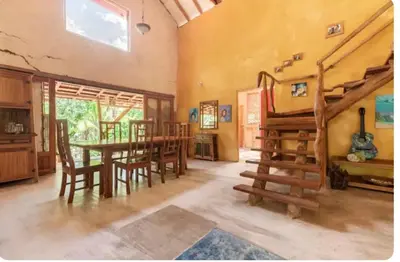 a living room with a table and a dining room at Casa BAMBÚ, enjoy nature in San Juan de Mata