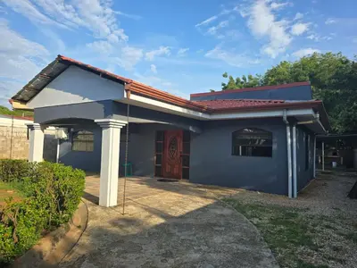 a small blue house with a red roof at Casa Naboo in Santa Cruz