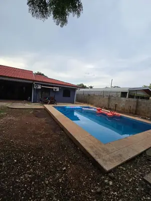 a swimming pool in the backyard of a house at Casa Naboo in Santa Cruz