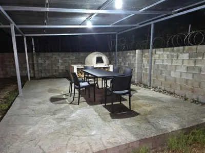 a black table and chairs on a patio at Casa Naboo in Santa Cruz