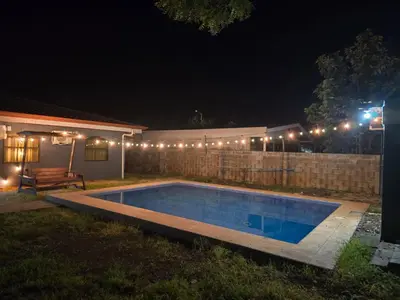 a swimming pool in a yard at night at Casa Naboo in Santa Cruz