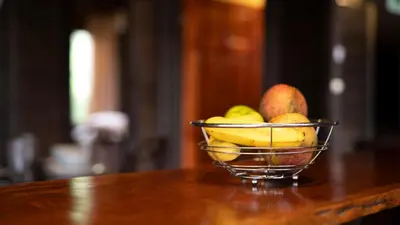 a bowl of fruit sitting on a table at The Toucan Nest - AC, Gated & Pool in Fortuna