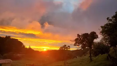 a sunset with the sun setting in the sky at Grand Luna - Monteverde in Tilarán