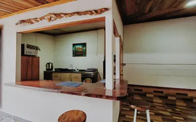 a kitchen with a counter and two stools at Grand Luna - Monteverde in Tilarán