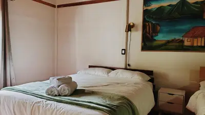 a bedroom with a bed with a stuffed animal on it at Grand Luna - Monteverde in Tilarán