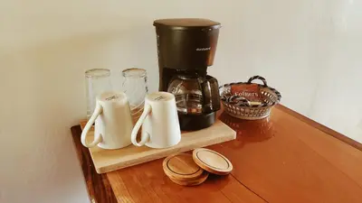 a counter with a coffee maker on a wooden shelf at Grand Luna - Monteverde in Tilarán
